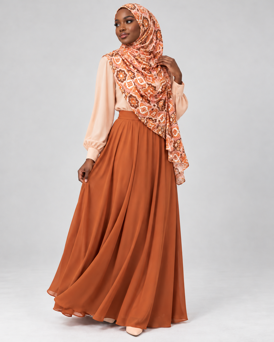 Woman wearing the rust brown geometric hijab